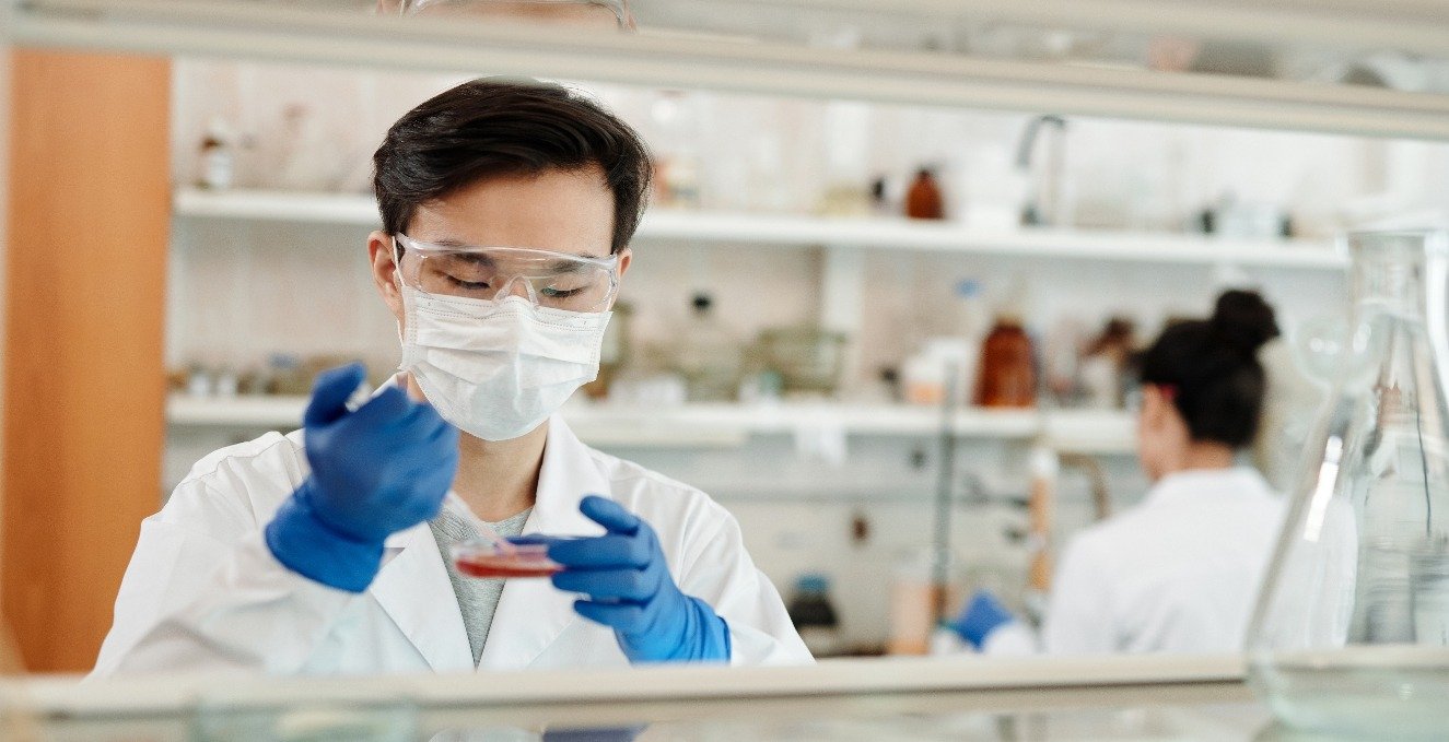 Researcher working with petri dish in lab